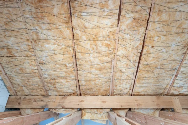 House under construction with insulation glass wool on an attic floor — Stock Photo, Image