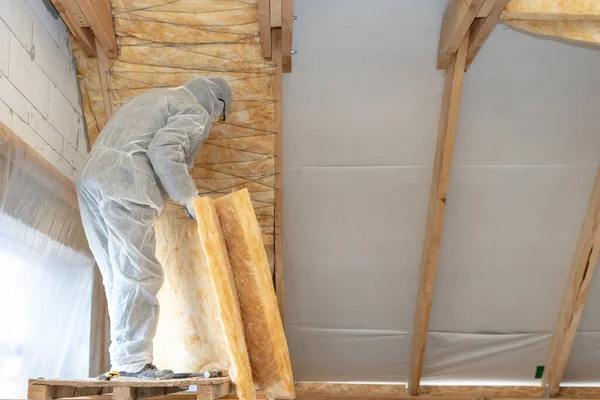 Professional workman installing thermal insulation layer with mineral rock wool — Stock Photo, Image