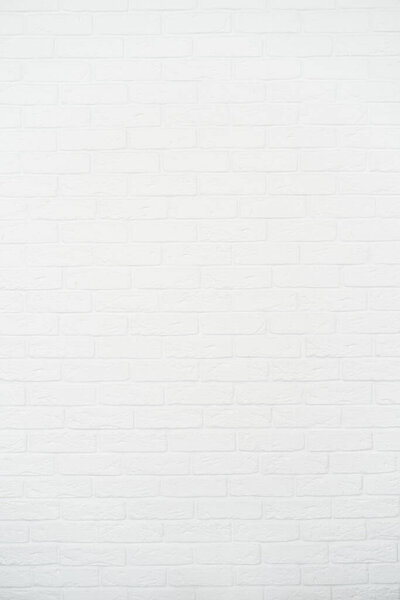 Vertical photo of new modern interior room in bright apartment with copy space on white brick wall