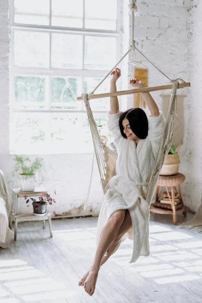 Vertical Photo Happy Young Adult Woman Bathrobe Raised Hands Sitting — Stock Photo, Image