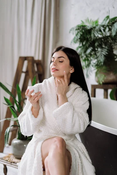 Vertical Photo Young Adult Woman Bathrobe Apply Face Cream Skin — Stock Photo, Image