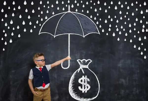 Kid businessman with umbrella protect money and business from crisis. Drawn umbrella and big bag of money — Stock Photo, Image