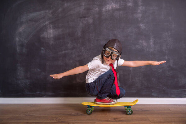 Kid with pilot helmet. Child playing at home. Success, imagination and innovation technology concept.