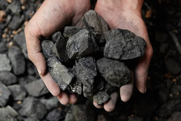 Madenci kömür arka plan adam elinde. Kömür madenciliği veya enerji kaynağı, çevre koruma. Endüstriyel kömürler. Volkanik kayalar.