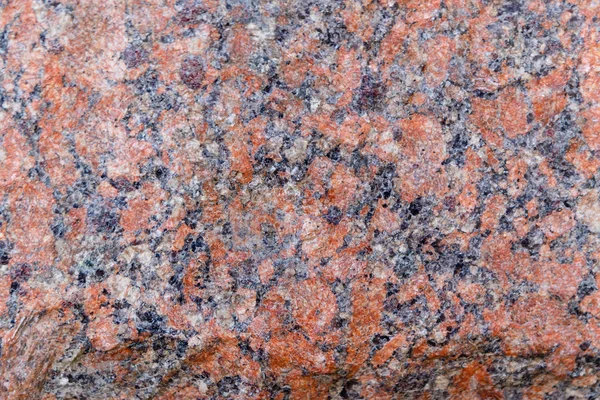 Natural mountain red granite background with impregnation of min