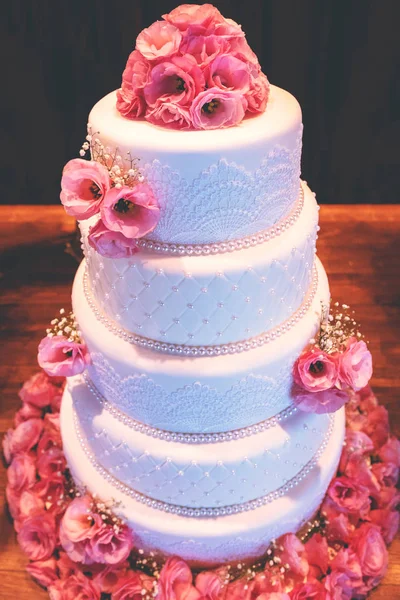 Wedding cake, cake for a wedding. Cake decoration with colorful flowers.