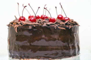 Fotoğraf bir lezzetli Black Forest pastadan kiraz ile dekore edilmiştir. Beyaz arka plan üzerinde izole.