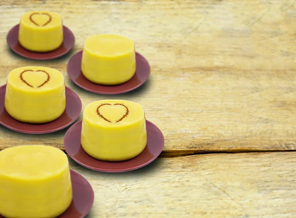 Typical Brazilian dessert, sweet of mingua, called in Brazil of curau. Typical sweet of June party. Brazilian sweet corn, corn mousse on a wooden background with copy space.