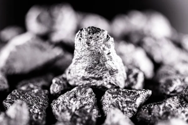 Mangan im rohen Zustand. Manganstein isoliert auf schwarzem Hintergrund. Abbau von Schwermetallen. — Stockfoto