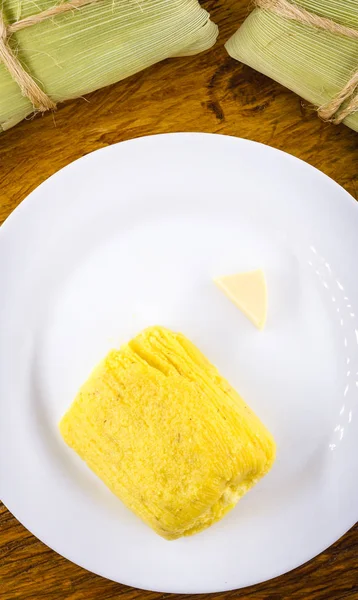 pamonha, Brazilian sweet made from homemade cheese with corn. Open pissing ready for consumption. Concept of traditional Brazilian sweet, typical food of the months of June and July.