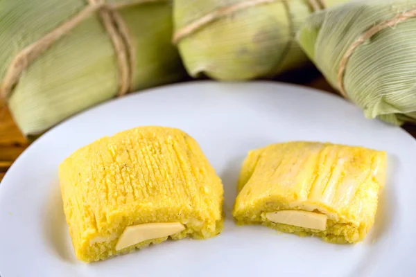 pamonha, Brazilian sweet made from homemade cheese with corn. Open pissing ready for consumption. Concept of traditional Brazilian sweet, typical food of the months of June and July.