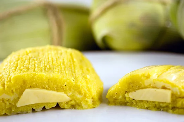 pamonha, Brazilian sweet made from homemade cheese with corn. Open pissing ready for consumption. Concept of traditional Brazilian sweet, typical food of the months of June and July.