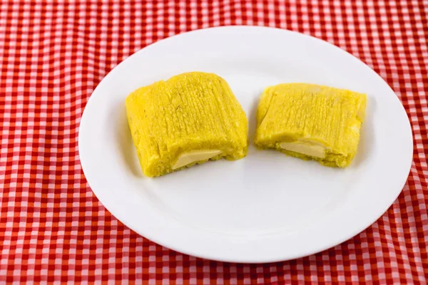 Pamonha, Brazilian sweet corn with cheese filling. Pamonha typical of Brazil, food of the state of minas gerais and goiais. Concept of traditional food. Brazilian food at rural parties in June and Jul