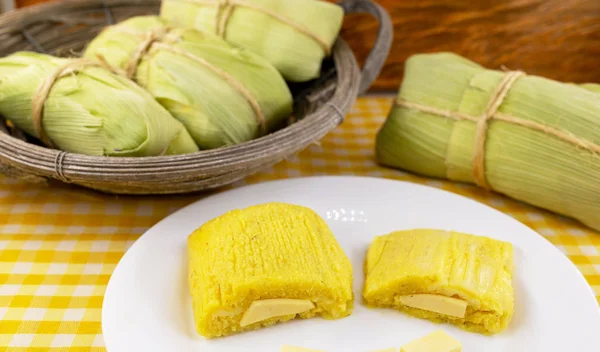 pamonha, Brazilian sweet made from homemade cheese with corn. Open pissing ready for consumption. Concept of traditional Brazilian sweet, typical food of the months of June and July.