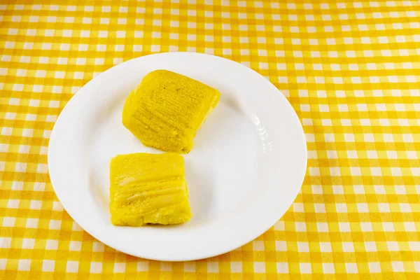 pamonha, Brazilian sweet made from homemade cheese with corn. Open pissing ready for consumption. Concept of traditional Brazilian sweet, typical food of the months of June and July.
