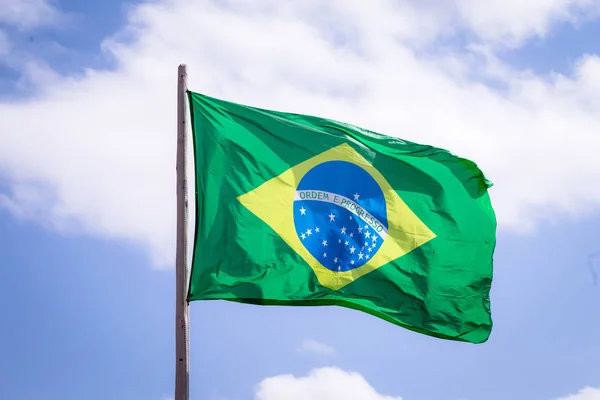 Brazil national flag textile cloth waving on top, blue sky brazil, patriotism concept.