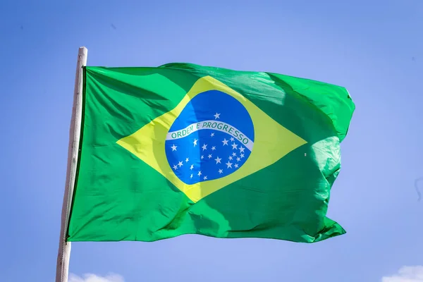 Brazil national flag textile cloth waving on top, blue sky brazil, patriotism concept.