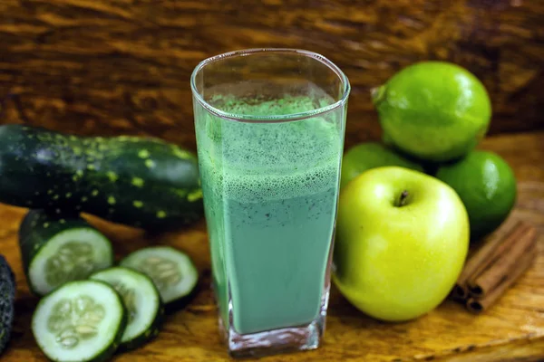 Green detox juice, kale leaves, lemon, apple, lettuce, cucumber, lime and other green vegetables. Copy space. Vegetarian juice, alkaline food concept. Healthy life. Copy space Raw, vegan, vegetarian.