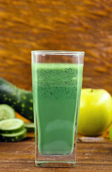 Green detox juice, kale leaves, lemon, apple, lettuce, cucumber, lime and other green vegetables. Copy space. Vegetarian juice, alkaline food concept. Healthy life. Copy space Raw, vegan, vegetarian.