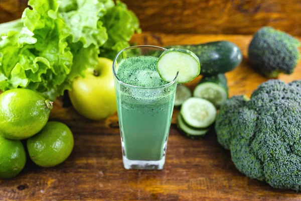 Green detox juice, kale leaves, lemon, apple, lettuce, cucumber, lime and other green vegetables. Copy space. Vegetarian juice, alkaline food concept. Healthy life. Copy space Raw, vegan, vegetarian.