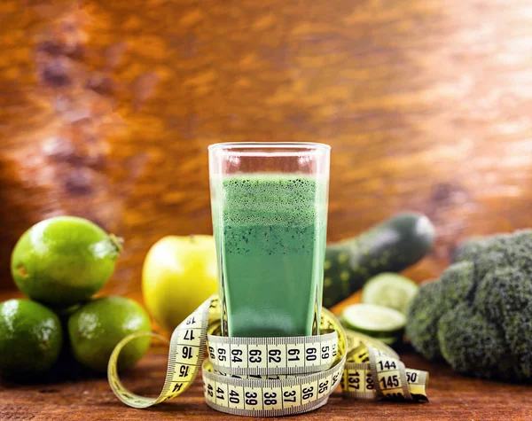 Brazilian detox juice and measuring tape. Detox drinks, green ju