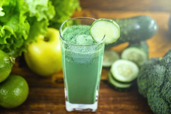 Green detox juice, kale leaves, lemon, apple, lettuce, cucumber, lime and other green vegetables. Copy space. Vegetarian juice, alkaline food concept. Healthy life. Copy space Raw, vegan, vegetarian.