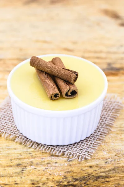 Brezilya tatlı mısır kremi tatlı, canjica veya Jimbel, tatlı bir ahşap arka plan tarçın ile mısır mısır mus tedavi. Kopyalama alanı