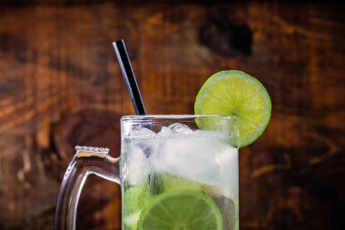 Beer caipirinha. Brazilian exotic drink of beer with lemon and cachaça.