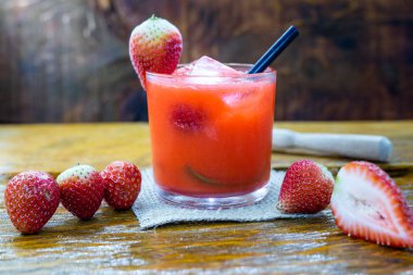 Ahşap arka planda taze çilek içeceği, Brezilya ÇilekCaipirinha barda yer. Metin için boşluk. Menü için fotoğraf.