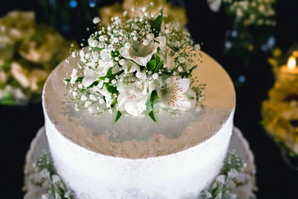 Rustic wedding concept. Wedding cake decorated with flowers.