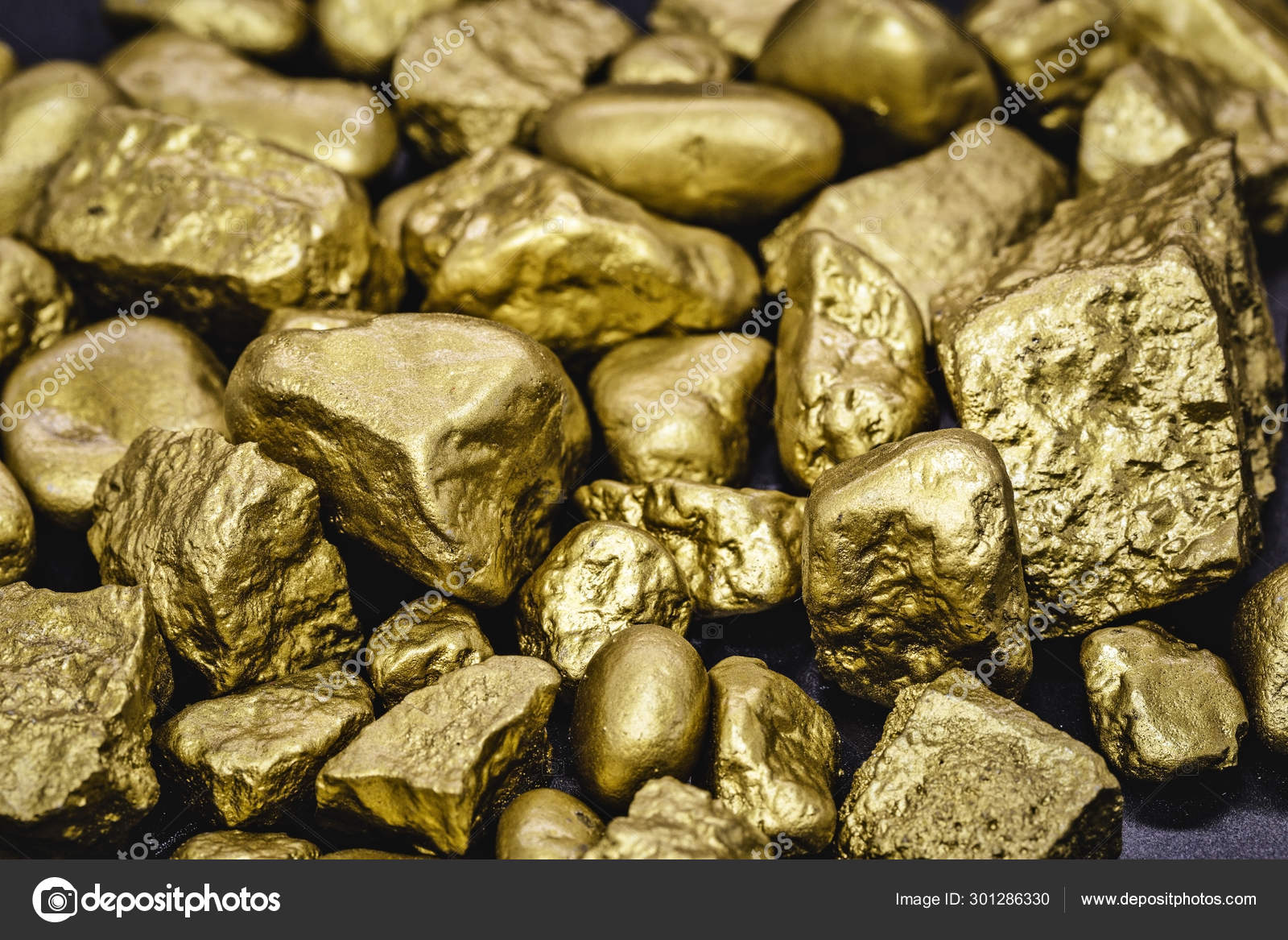 Golden nuggets isolated on black background. Luxury concept and gold