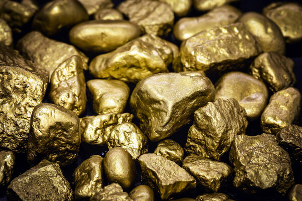 Golden nuggets isolated on black background. Luxury concept and gold.
