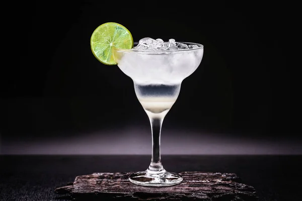 Frozen margarita in glasses, refreshing lemon alcohol drink and lots of ice, summer drink.