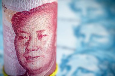 100 Yuan 'lık banknotlar, bulanık arkaplanda Brezilya' dan 100 reais banknotlar. Çin piyasa değeri ve Renminbi para birimi