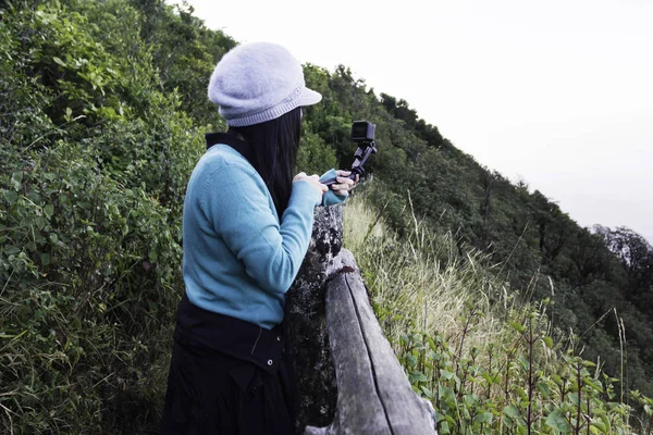 Asian women shooting photo and video with action camera in top o — Stock Photo, Image