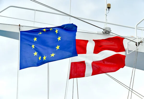 stock image The flags of the EU and the state of Denmark side by side on a mast of a ship