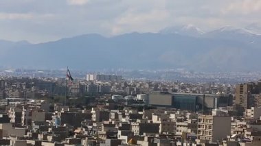 Binaların üzerinde güneş ışığı ile İran İslam Cumhuriyeti'nin başkenti Tahran şehir manzarası uzun çekim