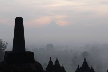 Gizemler orman şafakta, Yogyakarta, Endonezya çevreleyen ile siluet Borobudur Tapınağı 