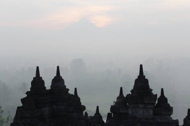 Gizemler orman şafakta, Yogyakarta, Endonezya çevreleyen ile siluet Borobudur Tapınağı 