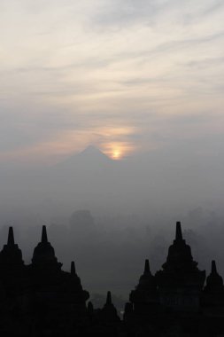 Gizemler orman günbatımı sırasında Yogyakarta, Endonezya çevreleyen ile siluet Borobudur Tapınağı