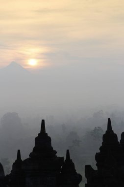Gizemler orman günbatımı sırasında Yogyakarta, Endonezya çevreleyen ile siluet Borobudur Tapınağı