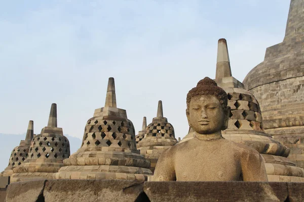 Borobudur Temple with the Buddha statue during sunrise, Yogyakarta, Indonesia