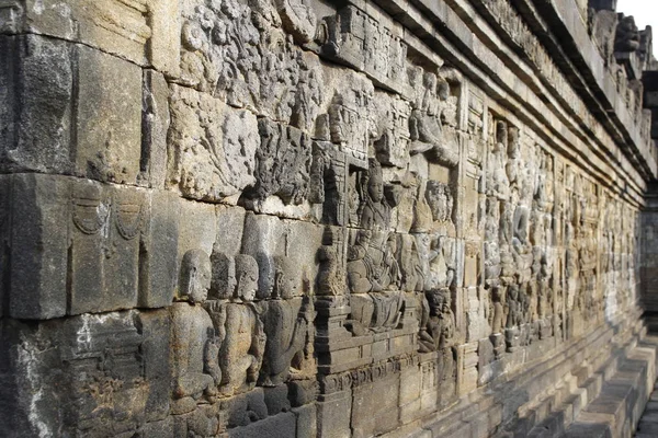 Beautiful bas-relief wall decor carved in stone at Borobudur Temple, Yogyakarta, Indonesia