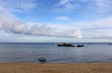 View of Tioman Island with the dramatic cloudscape, boats and rocks in the morning, Tioman Island 