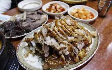 Focus on the Korean style braised pork belly with the side dishes at Korean restaurant, Seoul, South Korea