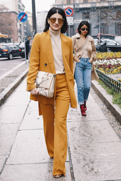 Milan, Italy - February 22, 2018: Fashion influencer wearing Max Mara bag, posing before Max Mara show during Milan Fashion Week.