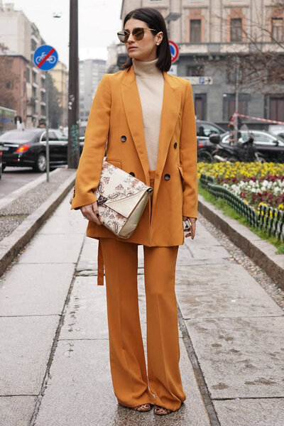 Milan, Italy - February 22, 2018: Fashion influencer wearing Max Mara bag, posing before Max Mara show during Milan Fashion Week.