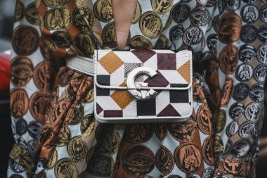 Milan, Italy - February 23, 2019: Street style Roberto Cavalli purse detail before a fashion show during Milan Fashion Week - MFWFW19 clipart