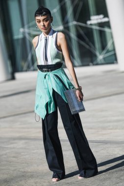 Milan, Italy - February 22, 2019: Street style Outfit before a fashion show during Milan Fashion Week MFWFW19 clipart
