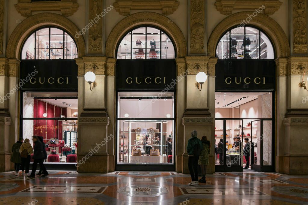 Milan, Italy - January 13, 2020: People in front of Galleria Vittorio Emanuele II Gucci showcases at night